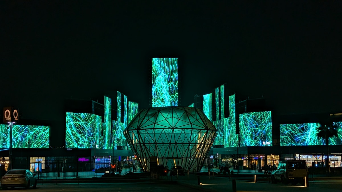 LED light installations illuminate a geodesic dome and towers at Riyadh Boulevard entertainment district at night