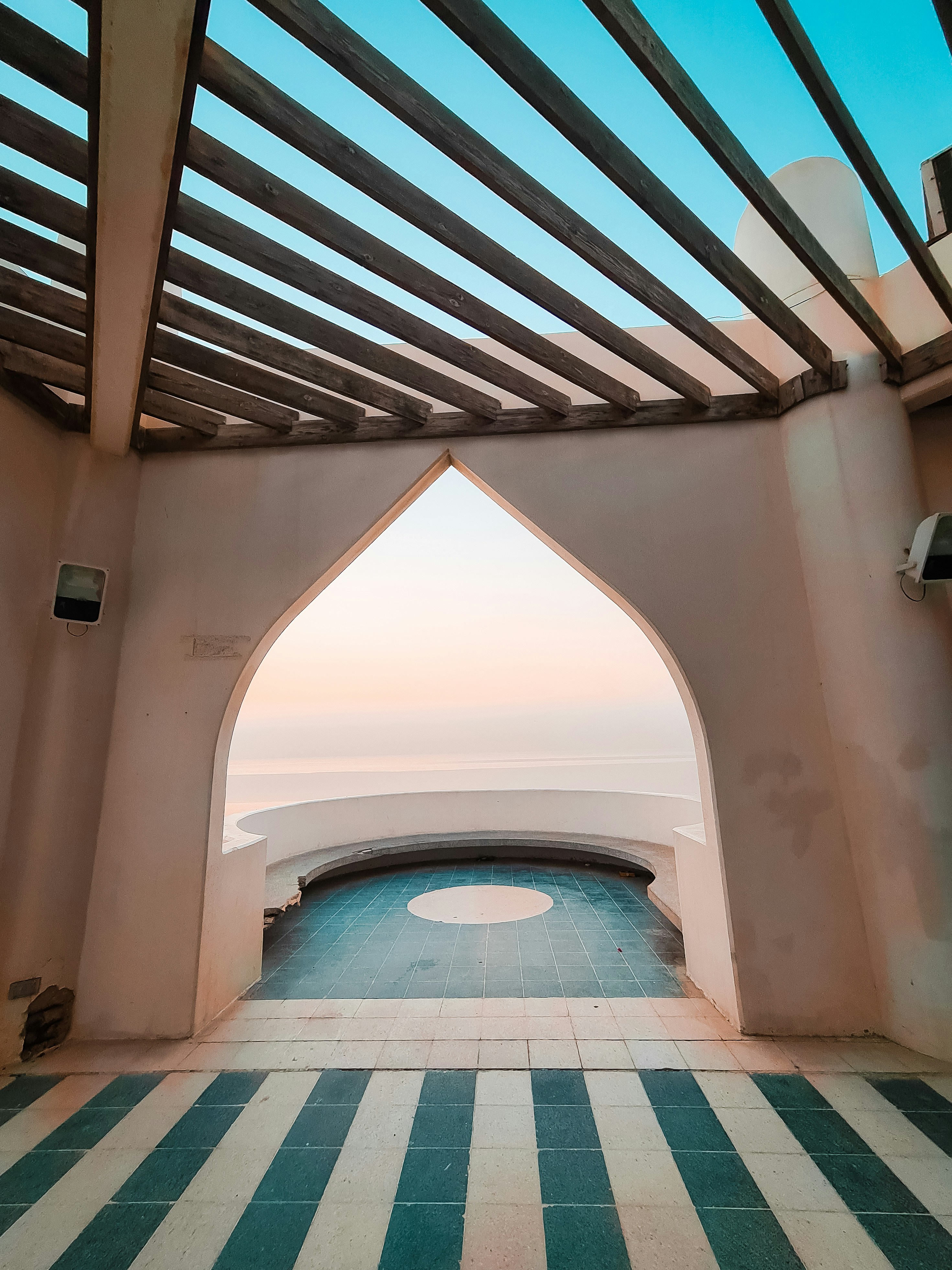 View of the Arabian Gulf through an Islamic pointed arch at the Al Khobar waterfront, Saudi Arabia