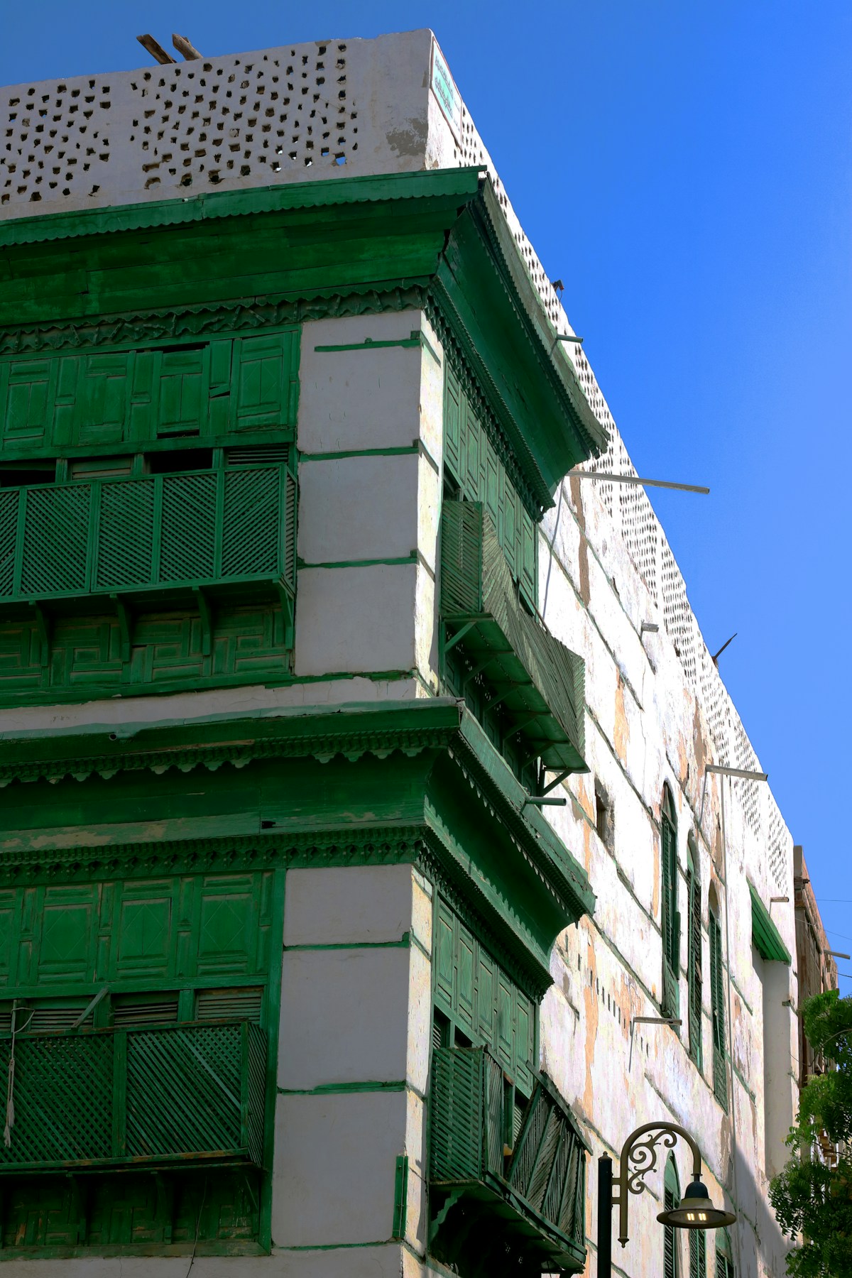 Traditional coral house with green wooden roshan balconies in Al-Balad, Jeddah
