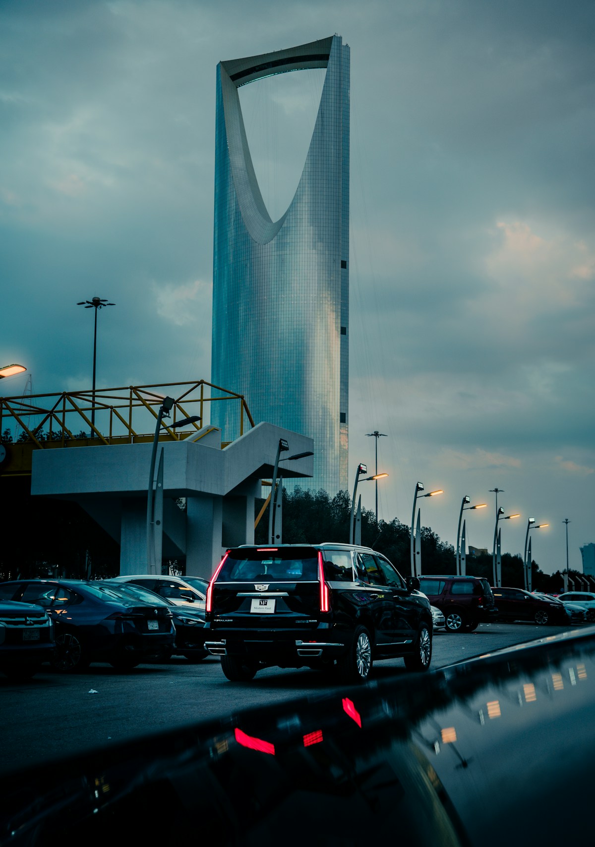 Kingdom Centre Tower in Riyadh at dusk with traffic on King Fahd Road, Saudi Arabia