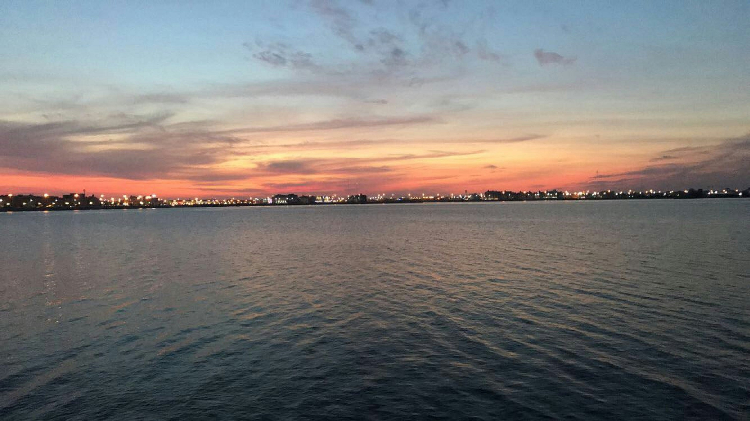 Dammam waterfront at sunset with city lights reflecting on the Arabian Gulf, Eastern Province, Saudi Arabia