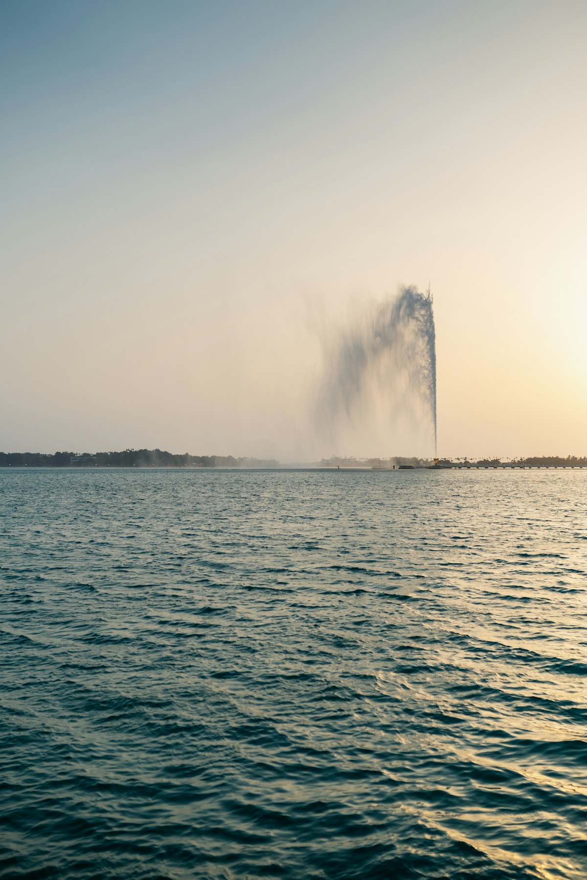 King Fahd Fountain shooting water high above the Red Sea at sunset in Jeddah
