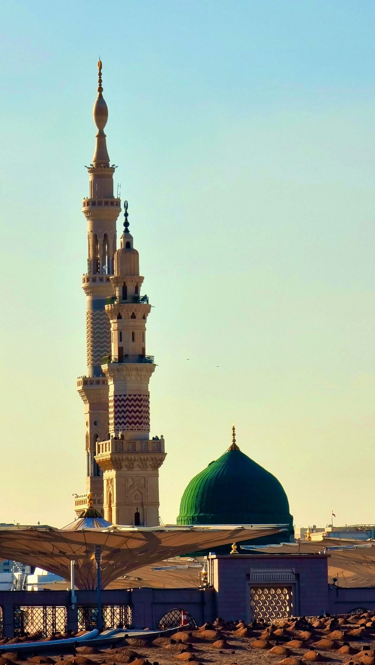 Prophet's Mosque green dome and minaret at golden hour, Medina, Saudi Arabia