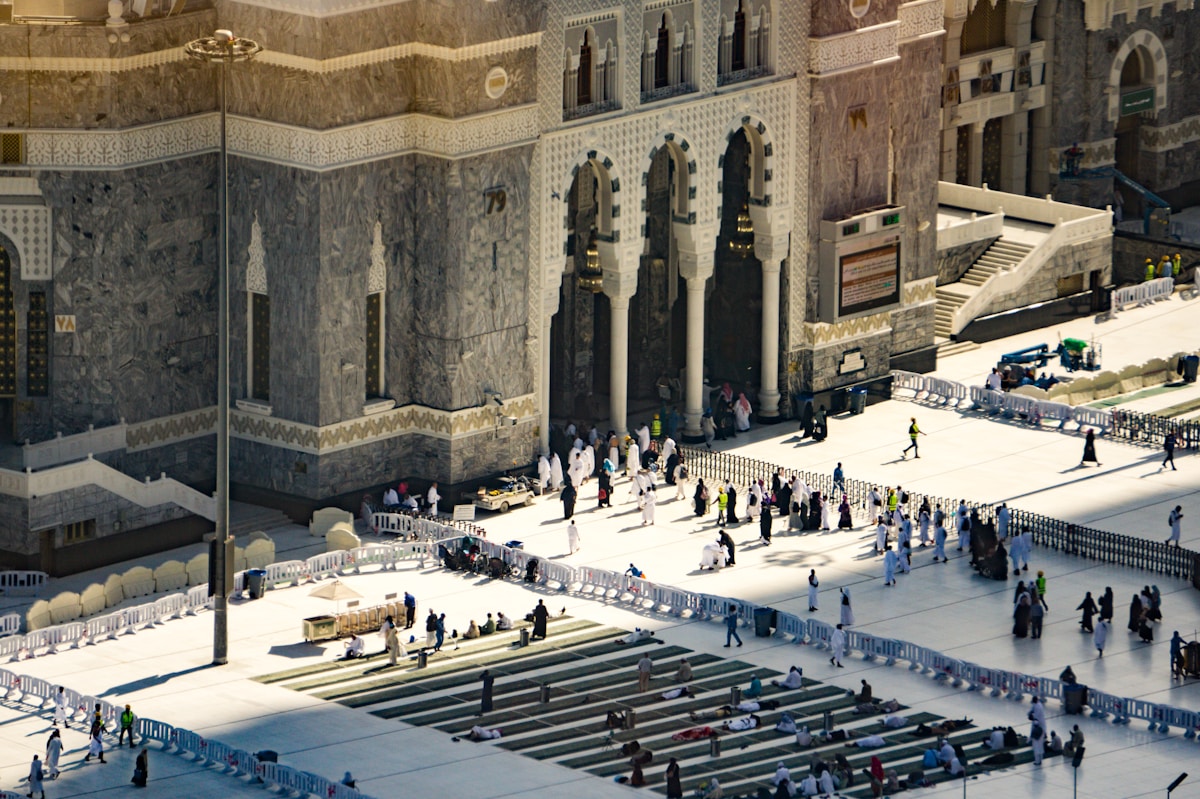 Pilgrims walking through the courtyard of Al-Masjid al-Haram in Mecca during Umrah