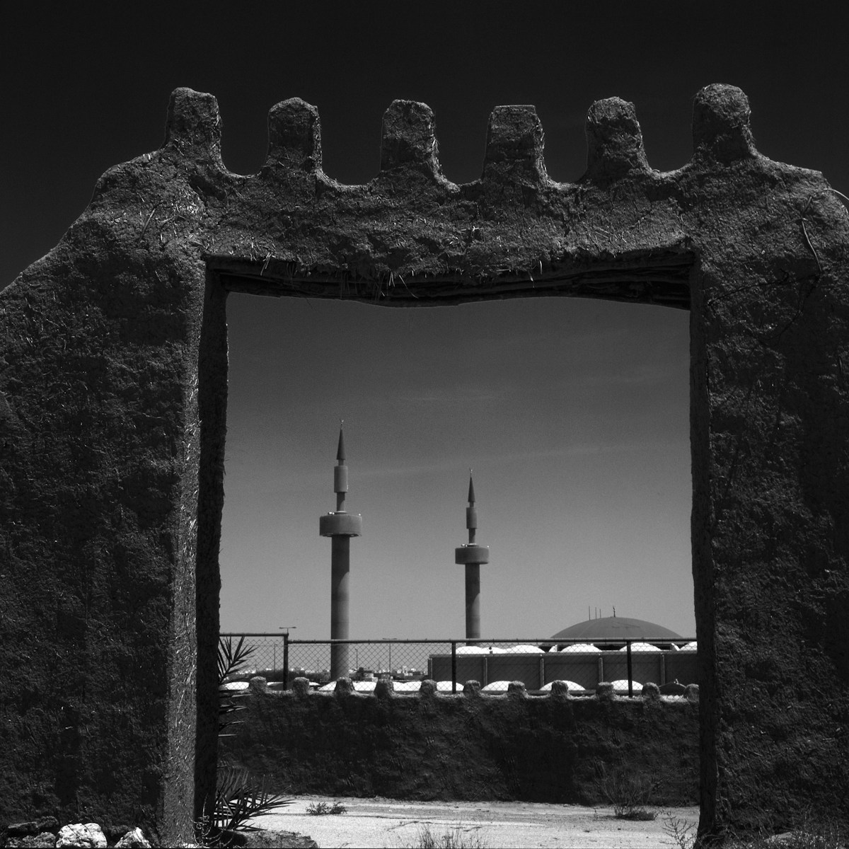 Stone archway framing mosque minarets and dome in Riyadh, Saudi Arabia