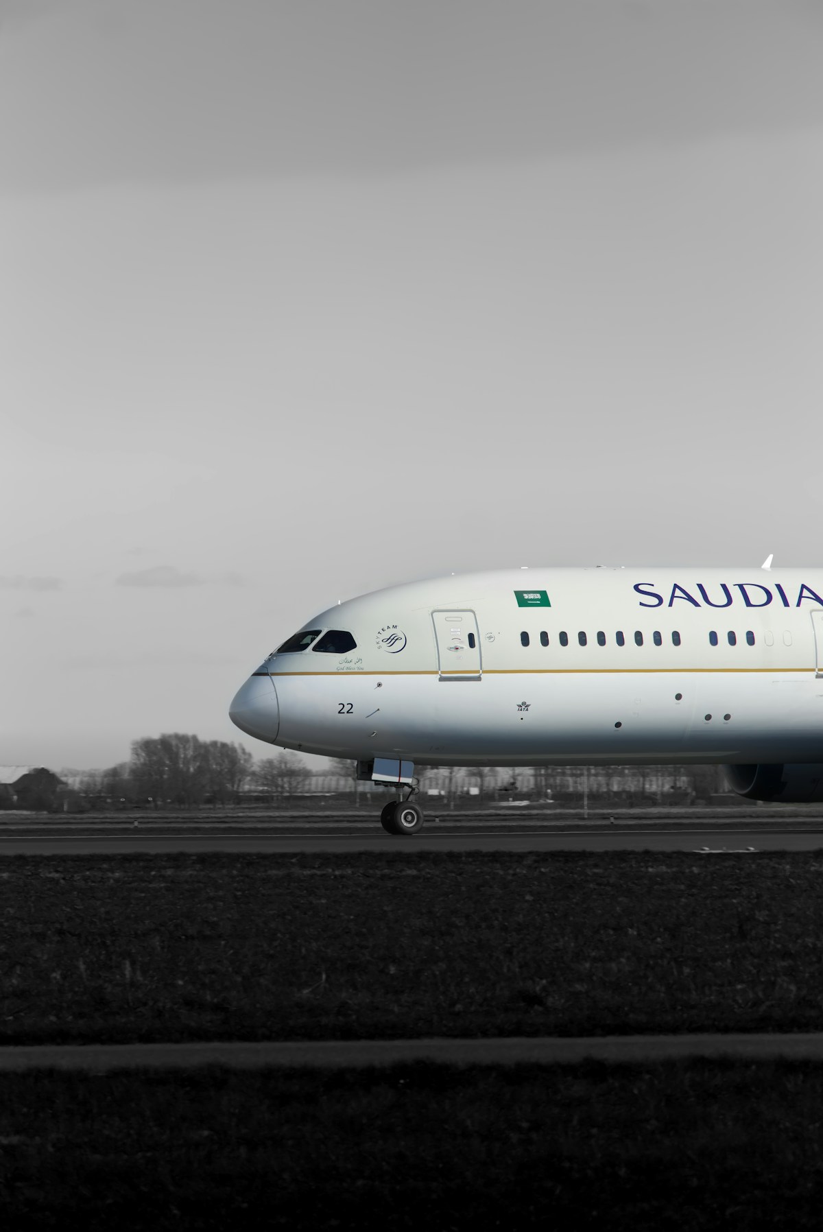 Saudia Boeing 787 passenger jet taxiing on an airport runway