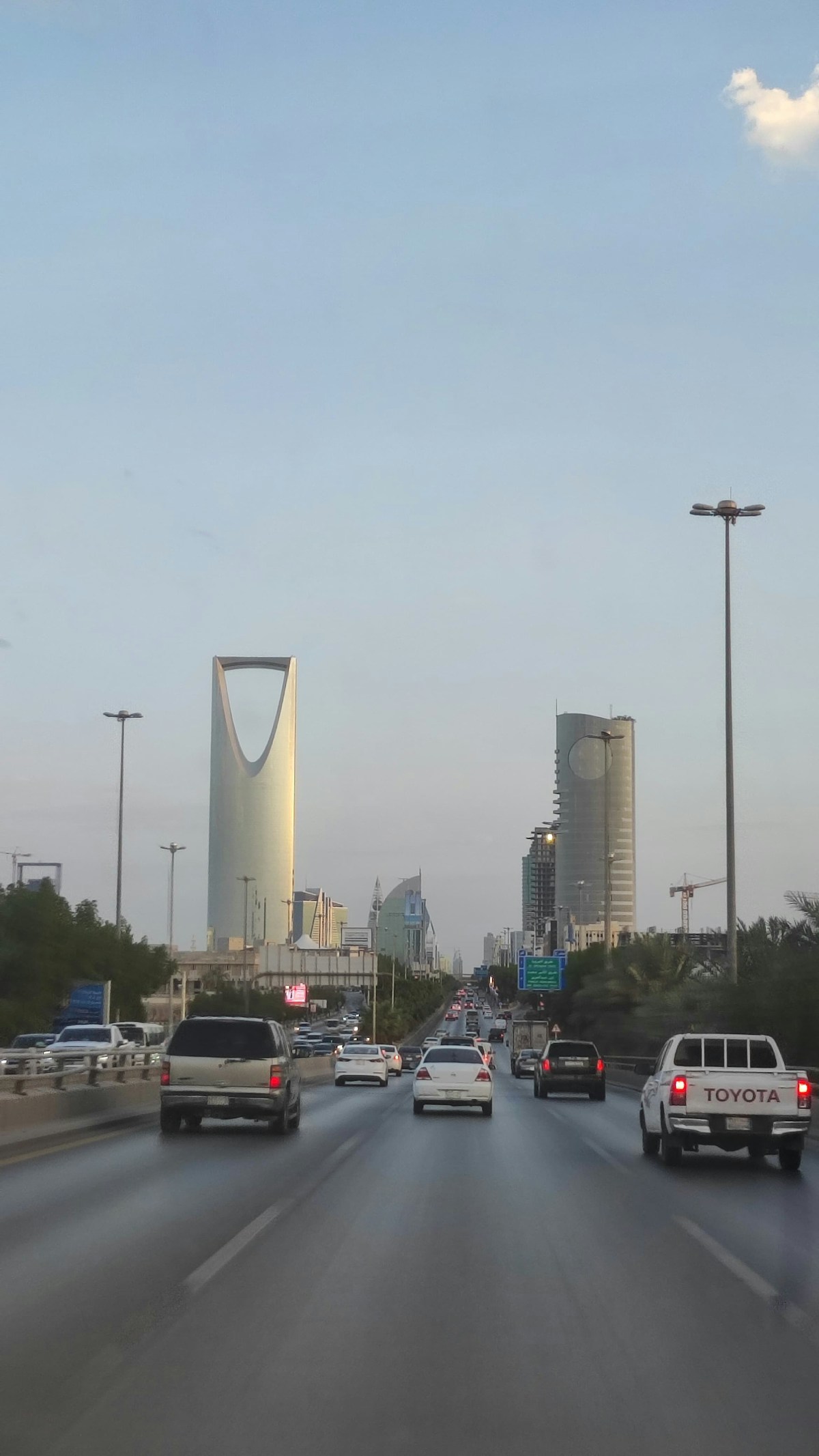 Busy highway in Riyadh with Kingdom Tower visible in the background, Saudi Arabia