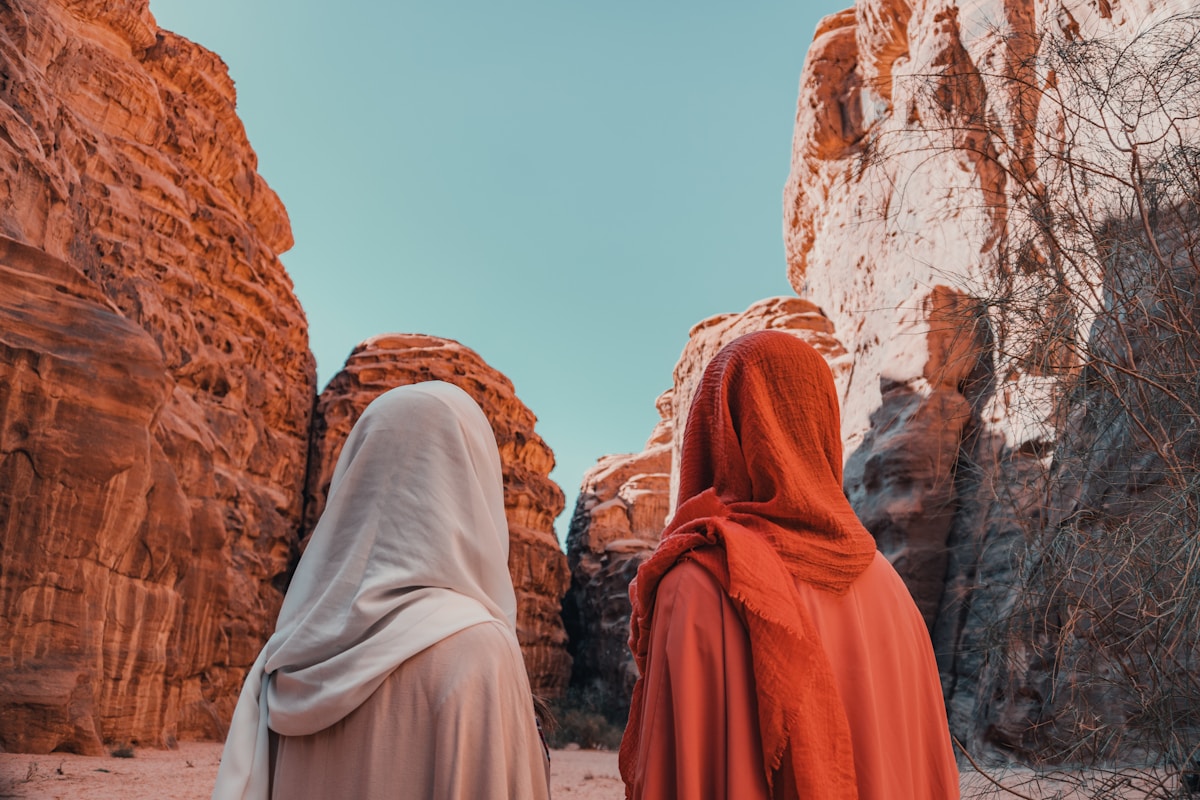 Tourists walking through a sandstone heritage site in Saudi Arabia