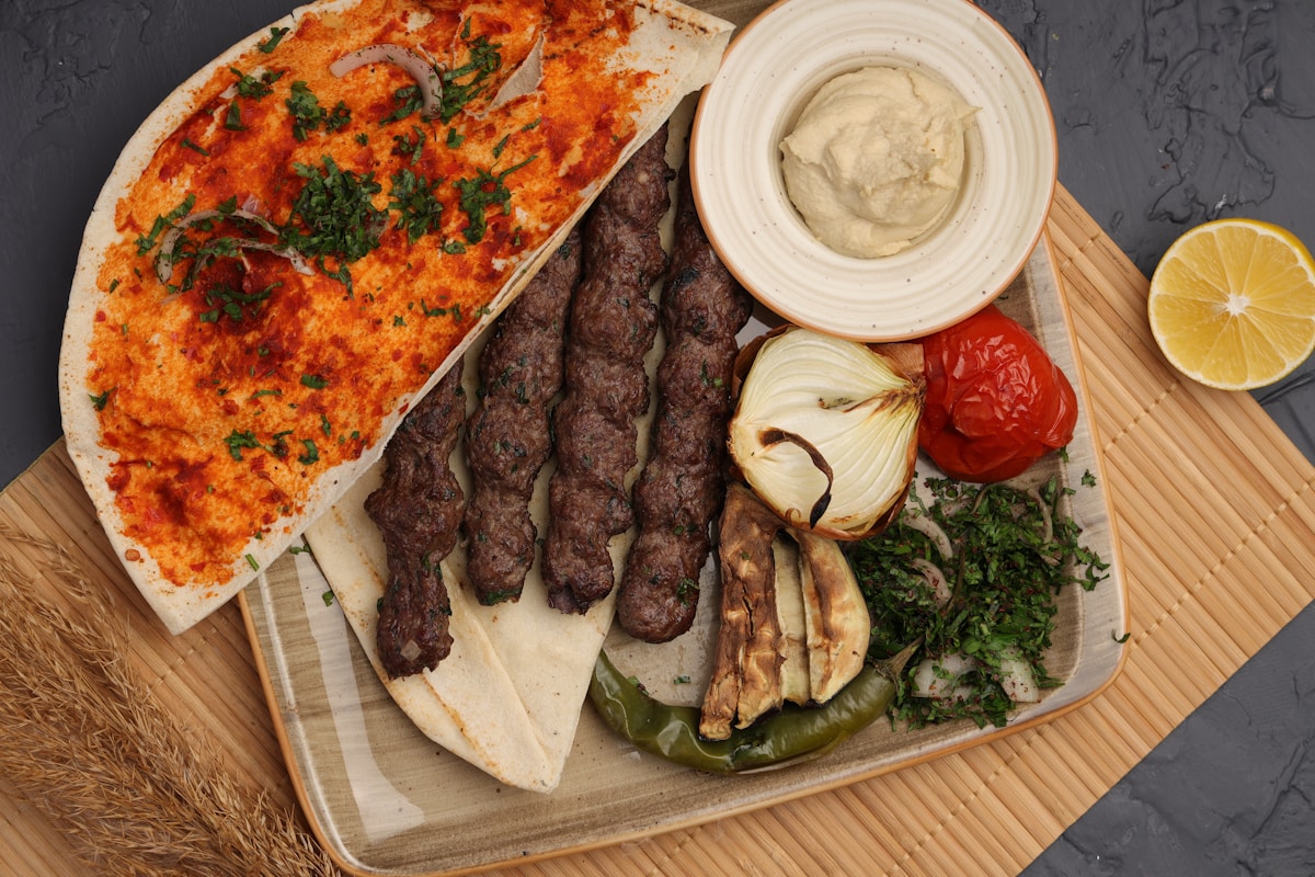 Saudi-style kebab platter with hummus and grilled vegetables on a restaurant table in Riyadh