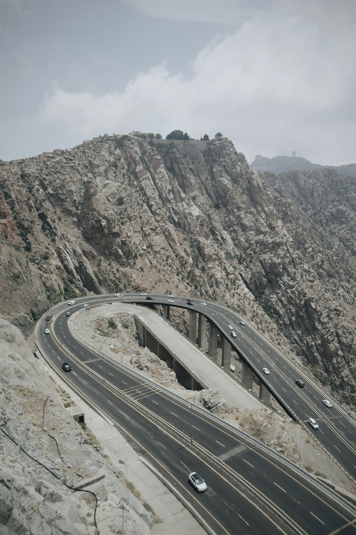 Mountain highway winding through rocky Al Hada mountains near Taif, Saudi Arabia