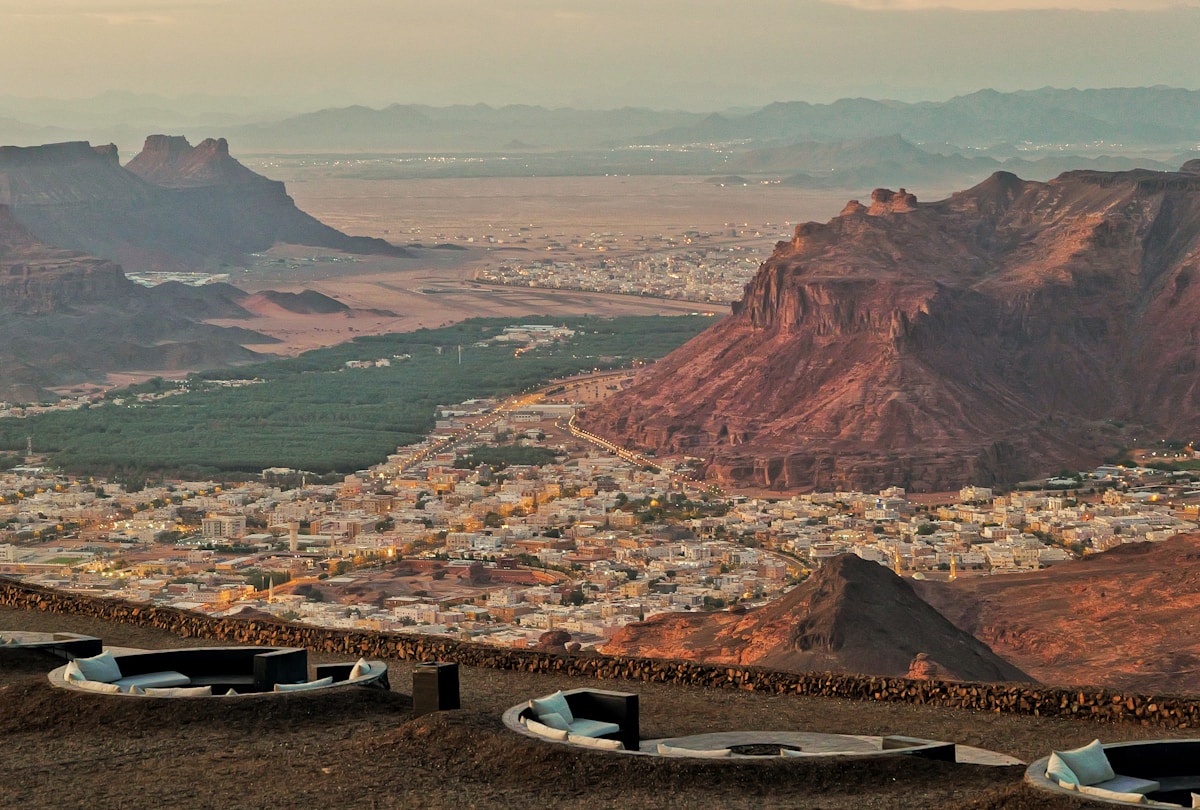Aerial view of a desert city in a mountain valley at dusk, Saudi Arabia